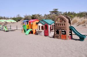 a row of colorful play structures on a beach at Hotel Riva dei Cavalleggeri in Marina di Bibbona