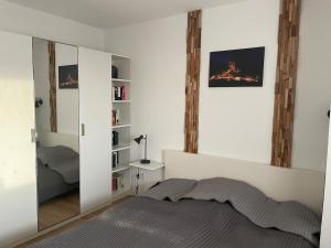 a bedroom with a bed and a mirror at gemütliche Ferienwohnung in Valwig