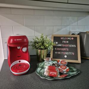 a kitchen counter with a red mixer and a box of food at Runway Hse Luxe 5 Bed, with King sized Beds, next to Aiport & NEC, JLR 5 mins in Marston Green