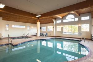 a swimming pool in a large room with windows at Holiday Inn Express Houghton-Keweenaw by IHG in Houghton