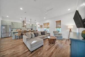 a living room with a couch and a kitchen at Saint Cecilia in Santa Rosa Beach