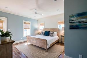 a bedroom with a bed and a painting on the wall at Saint Cecilia in Santa Rosa Beach +31 photos