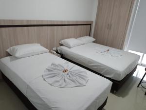 Postel nebo postele na pokoji v ubytování Hotel Nativo