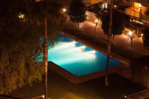 an overhead view of a swimming pool at night at Enjoybcn Marina Apartment in Barcelona