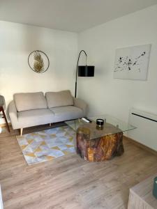 a living room with a couch and a tree stump coffee table at Le patio, T2 en centre ville in Montauban