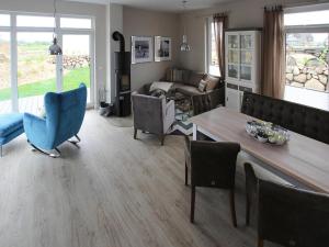 a living room with a table and chairs and a couch at Ferienhaus Fiete in Lancken in Lancken