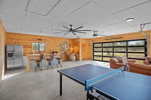 a living room with a ping pong table in it at 6 BR Hot Tub King Beds Game Room Tiled Showers in Fredericksburg