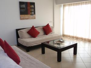 a living room with a couch and a coffee table at Parque Mourabel, Oásis Village & Pé do Lago in Vilamoura