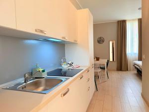 a kitchen with a sink and a counter top at Il Giardino degli Ulivi P1 in Lissone +154 photos