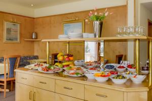 a table filled with plates and bowls of food at Hotel am Brenner in Tauberbischofsheim