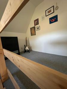 an attic room with a wooden staircase and pictures on the wall at Randy's House Plzeň in Pilsen