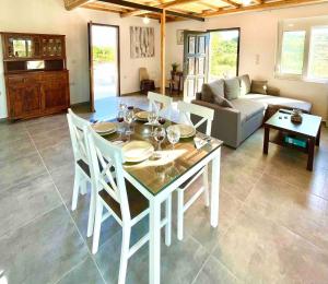 a living room with a table and chairs and a couch at Villa Voleonas-private pool & olive grove Chania in Kounoupidhianá +6 photos