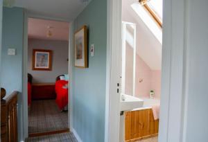 a bathroom with a sink and a bath tub at Coastal Kerry Hideaway - Sleeps 6 & Free Parking in Waterville