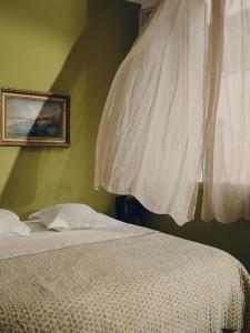 a bedroom with a bed with a white comforter and a window at La Maison d'Odette in La Ciotat +53 photos