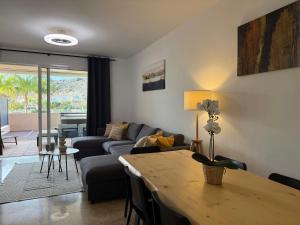 a living room with a couch and a table at Townhouse Playa Negra in Puerto de Santiago