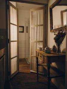 a room with a table and a mirror and a door at La Maison d'Odette in La Ciotat