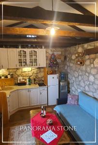 a kitchen with a christmas tree in a room at Panorama Stone Houses - Skadar Lake in Cetinje