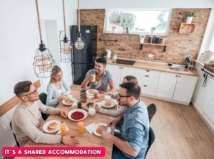 a group of people sitting around a table eating food at -RA27A- For your relaxed, Cosy stay, Free Parking in Leeds