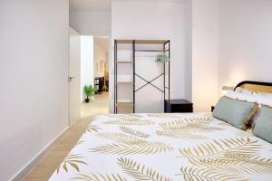 a bedroom with a large bed with a leaf printed bedspread at Rincón con Encanto en el Centro Histórico in Cartagena