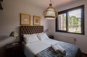a bedroom with a bed with two pillows on it at Locar-in Gramado - Cond Sonnendorf - Casa 09 B in Gramado