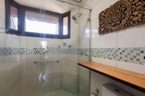 a bathroom with a shower with a glass door at Locar-in Gramado - Cond Sonnendorf - Casa 09 B in Gramado +30 photos