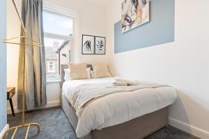 a bedroom with a bed and a window at Herschell House - Central Location - Free Parking, Fast Wifi, SmartTV with Netflix - Perfect for Contractors, Families and Groups by Yoko Property in Redcar +18 photos