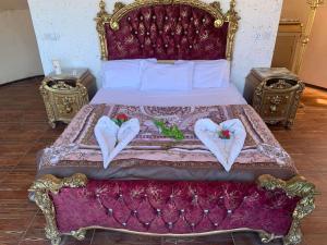 a bedroom with a bed with two hearts on it at Sami Rum Mountains in Wadi Rum