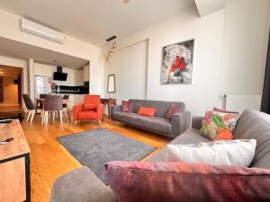 Una sala de estar con sofás y un comedor. en G Tower Residence at Divan Near To Mimar Sinan Metro Station, en Estambul