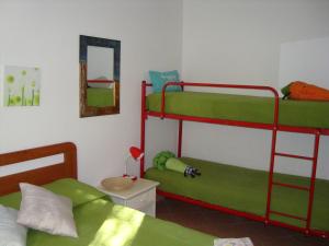a bedroom with two bunk beds and a mirror at Villa individuelle avec jardin in Sartène