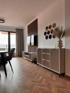 a living room with a television and a table at SeaView Etara IV Apartment in Sveti Vlas in Sveti Vlas