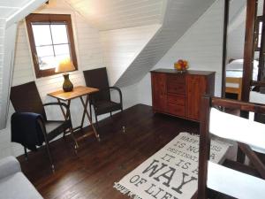 a room with a table and chairs and a bedroom at Wooden House by Baltic Sea & Wolin Park in Międzyzdroje +18 photos