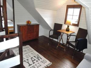 a room with a table and chairs in a attic at Wooden House by Baltic Sea & Wolin Park in Międzyzdroje