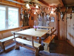 a dining room with a wooden table and benches at House in Wiejkowo near Szczecin Lagoon in Wiejkowo +29 photos