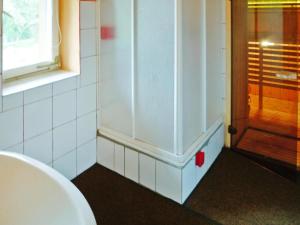 a bathroom with a toilet and a window and a door at House in Wiejkowo near Szczecin Lagoon in Wiejkowo