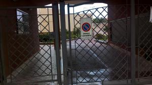 a gate with a no entry sign in a building at Appartamento Tulipano in Alghero +17 photos