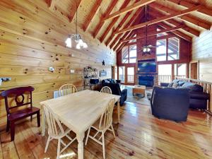 a dining room and living room with a wooden ceiling at The Overlook in Sevierville