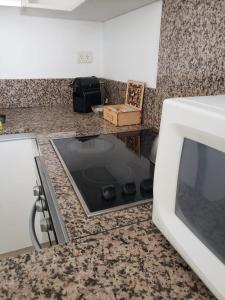 a kitchen with a counter top with a microwave at Comfortable Apartamento Semi Piso in Buenos Aires +13 photos