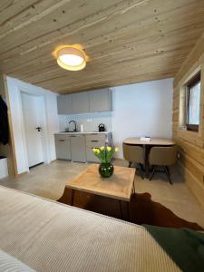 a room with a bed and a table and a kitchen at Chalôpka Terchová in Terchová