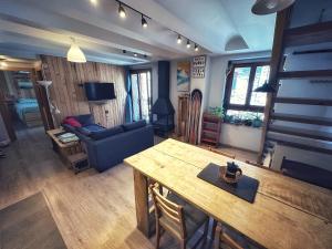 a living room with a table and a couch at La casa Pedalejo in Benasque