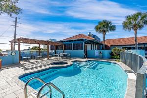 a swimming pool in front of a house at Beachside Inn in Destin