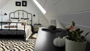 a bedroom with a bed and a table with a pumpkin at Thatched cottage in Dörgicse +26 photos