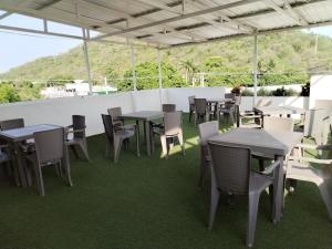 a group of tables and chairs on a patio at Villalba Boutique Hotel in Valledupar