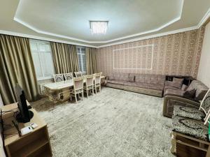 a living room with a couch and a table at Sun elit in Bishkek