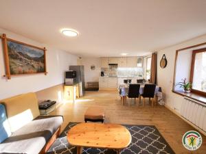 a living room with a couch and a table at L'École Buissonnière - Embrun in Embrun