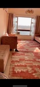 a living room with a couch and a rug at المعادي in Cairo