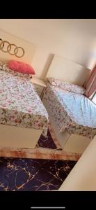 two beds sitting next to each other in a room at المعادي in Cairo