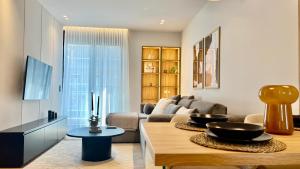 a living room with a couch and a table at The First by 22 in Piraeus