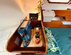 a sewing machine in a wooden box on a bed at Bacus - Your Floating Hideaway in Lisbon in Lisbon