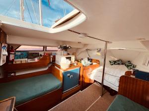 a room with a bed and a desk in a boat at Bacus - Your Floating Hideaway in Lisbon in Lisbon