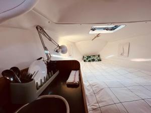 a small room with a bed in the back of a camper at Bacus - Your Floating Hideaway in Lisbon in Lisbon